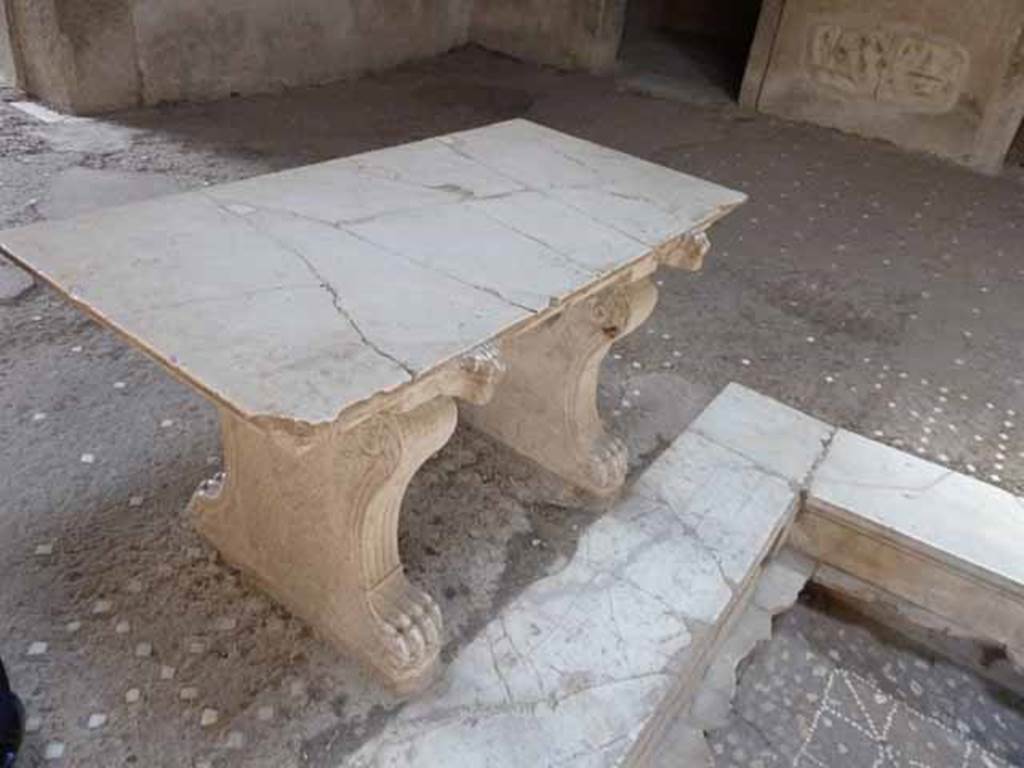 III.11 Herculaneum. May 2010. Room 6, looking south-east across marble table near impluvium.